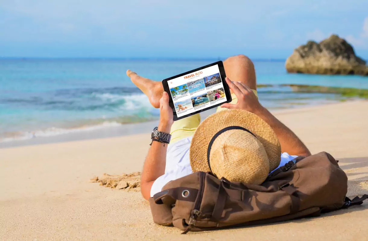 Travel Blogger working from the beach.