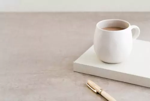 White coffee cup on notebook